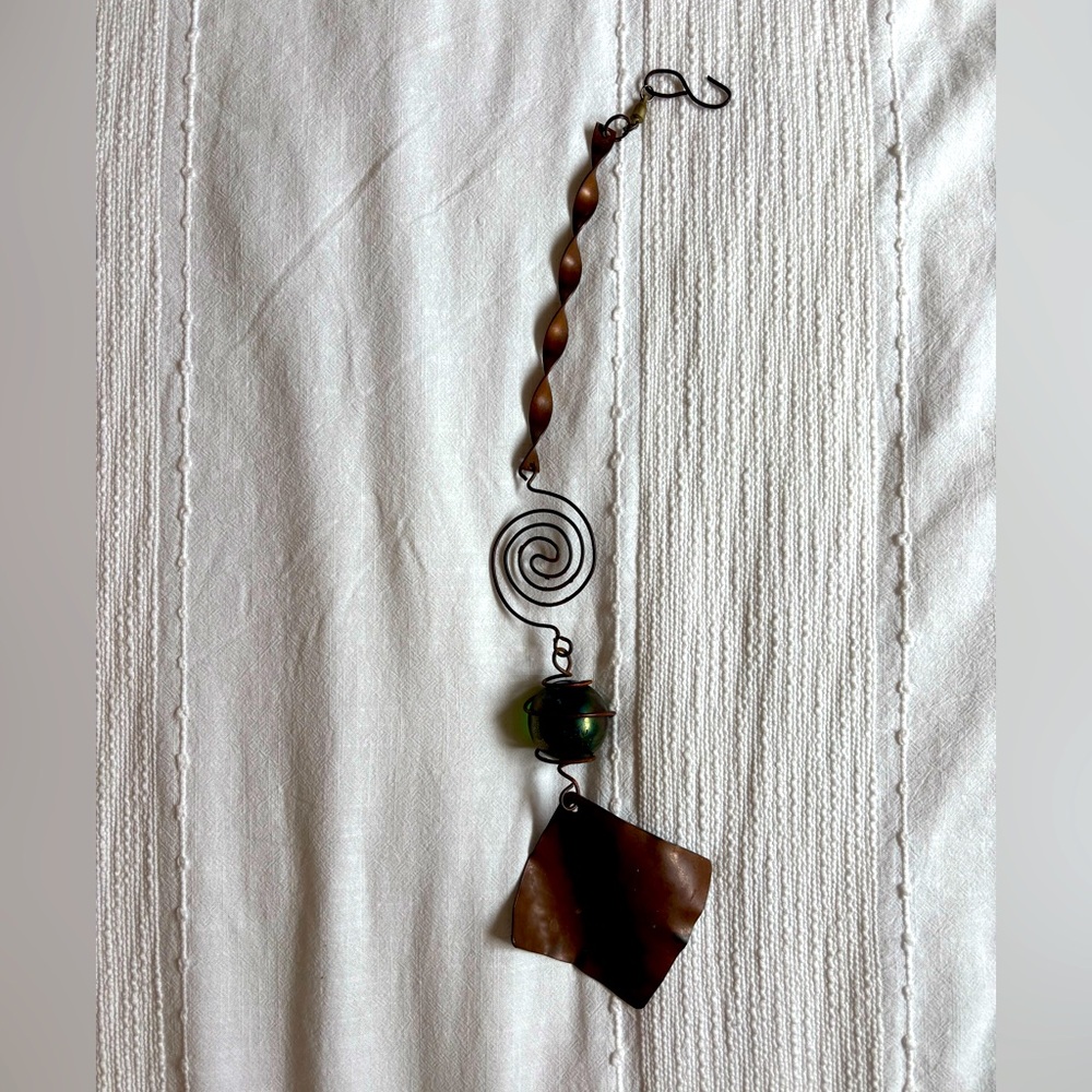 Rusty rustic windchime with green glass ball